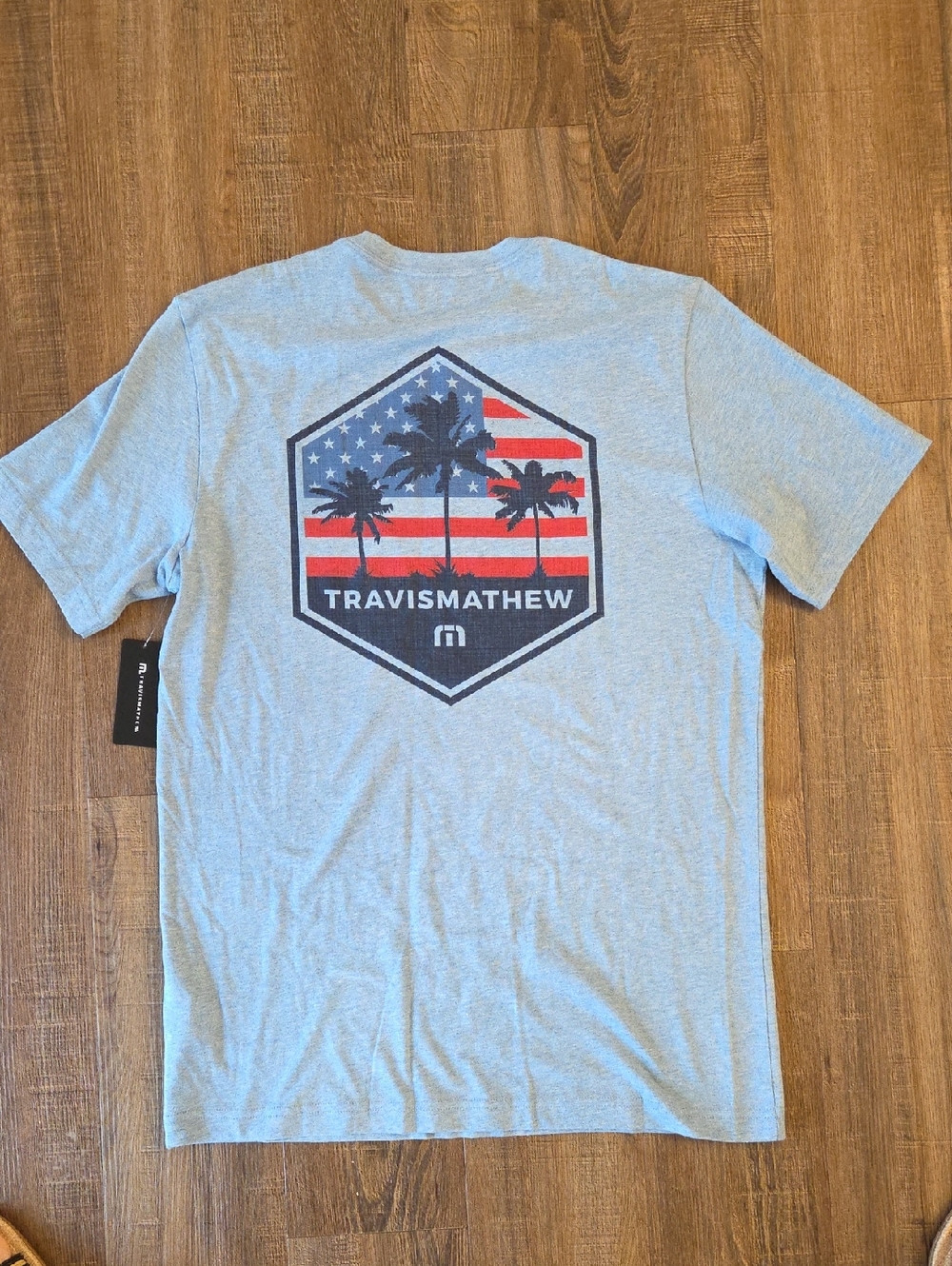 Travis Mathew Light Blue Tee with Red, Blue Palm Flag Graphic. NWT